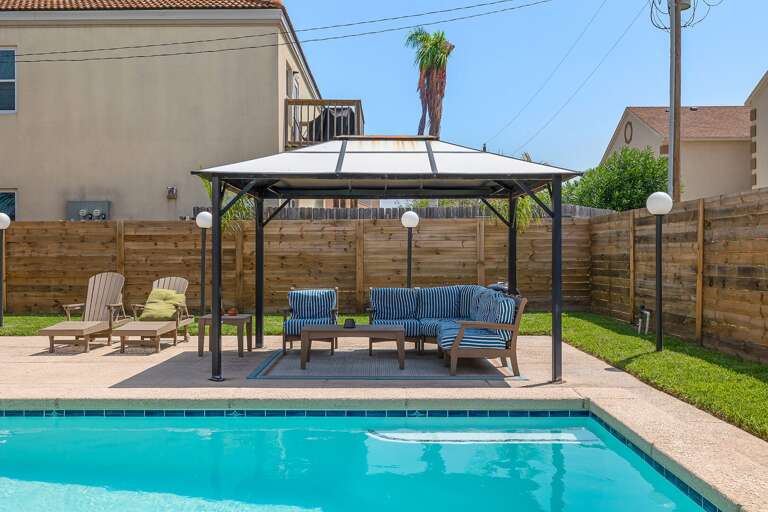 Poolside area features covered seating Poolside area features covered seating