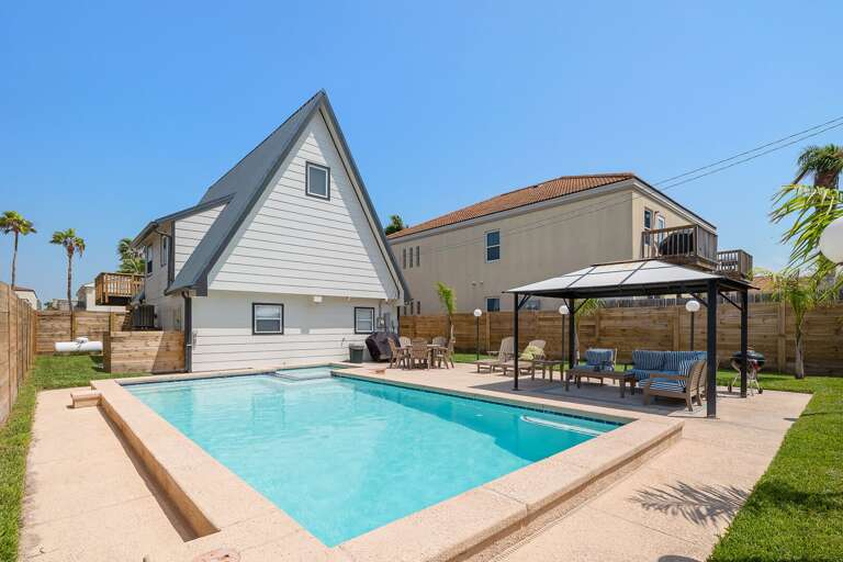 Sparkling swimming pool and outdoor seating, including lounge chairs!