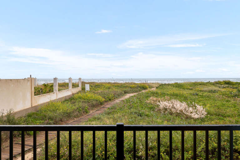 Your beachfront condo overlooks the ocean from the patio!