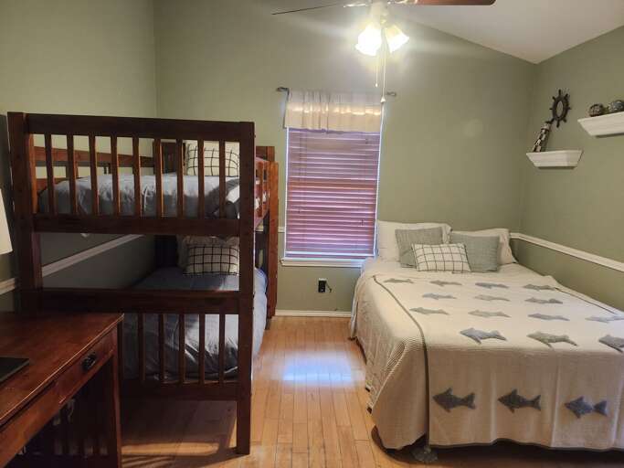 Bedroom 2 offers a queen-size bed, a twin-over-twin bunk bed, and a desk space, comfortably sleeping up to 4 guests. Bedroom 2 offers a queen-size bed, a twin-over-twin bunk bed, and a desk space, comfortably sleeping up to 4 guests.