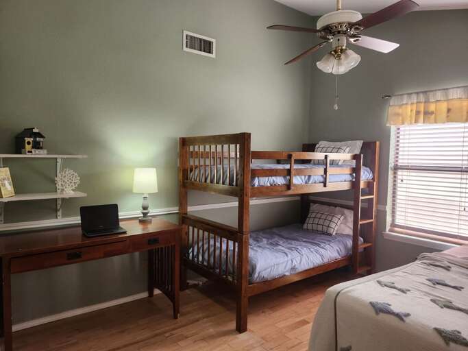 Bedroom 2 offers a queen-size bed, a twin-over-twin bunk bed, and a desk space, comfortably sleeping up to 4 guests. Bedroom 2 offers a queen-size bed, a twin-over-twin bunk bed, and a desk space, comfortably sleeping up to 4 guests.
