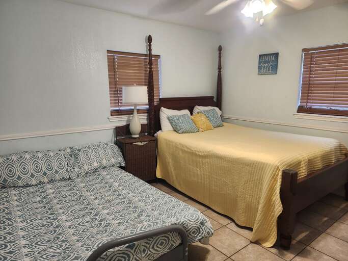 Bedroom 3 features a queen-size bed and a full-size futon, providing comfortable sleeping space for up to 4 guests.