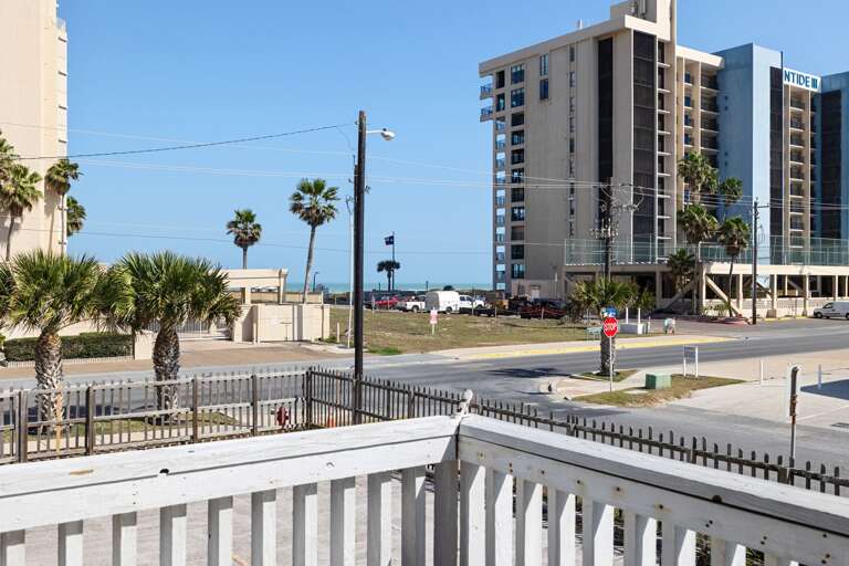 The front patio offers a great view, facing towards the beach access, ideal for enjoying the coastal breeze!
