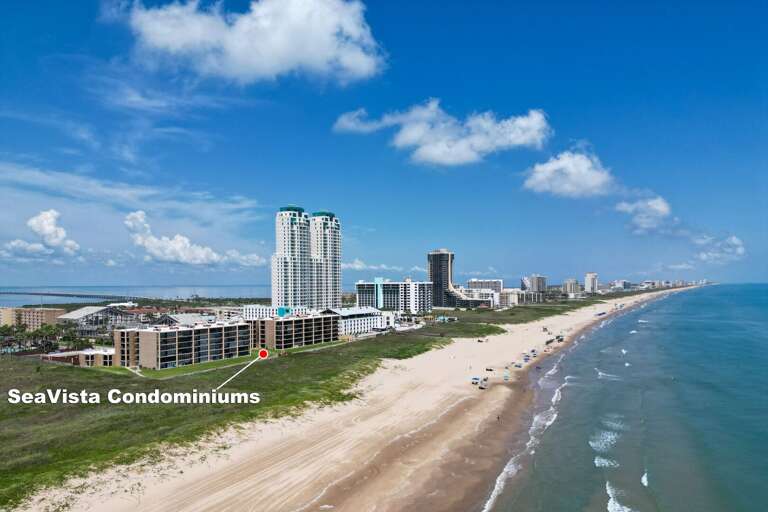 An aerial view showcases the property's incredible location directly along the South Padre Island beach.