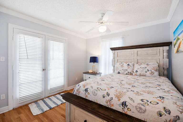 3rd Bedroom located on the 3rd floor with a Queen bed and access to the 3rd floor balcony.