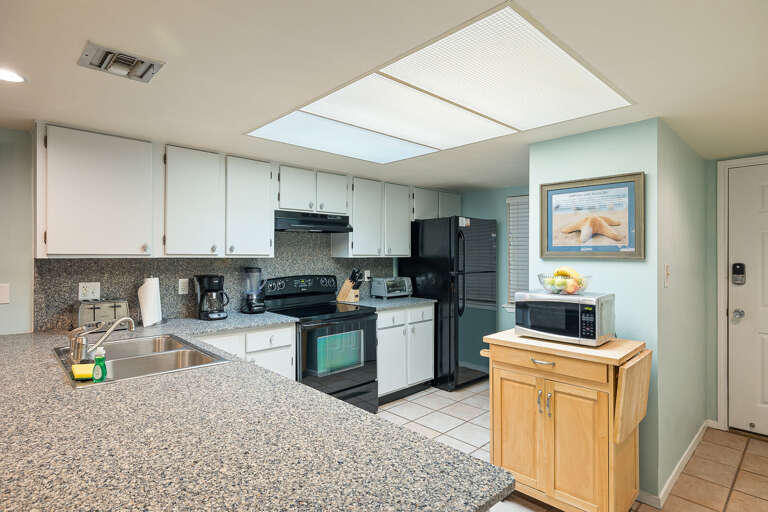 Kitchen is fully stocked with pots, pans, and utensils essential to prepare your home cooked meals