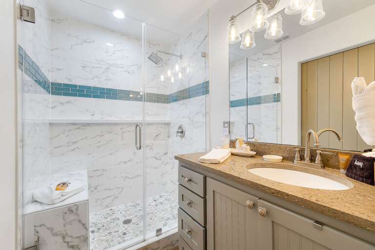 Bathroom features a walk-in shower with built-in bench.