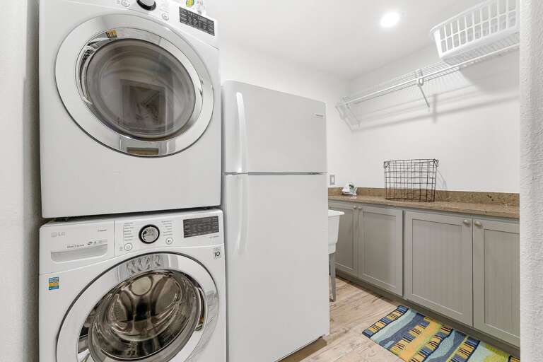 Full size laundry room on the second floor. Washer & dryer, additional refrigerator, large folding bar and a wash sink.