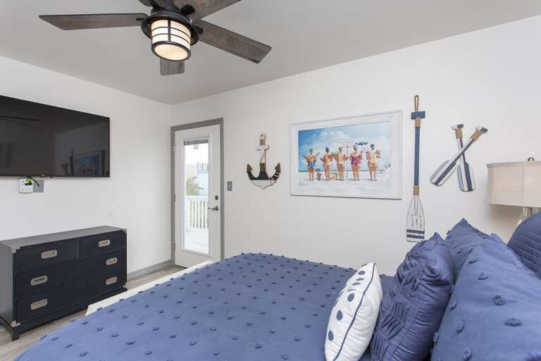 Large flat screen TV and private access to the shared balcony that over looks the pool area.