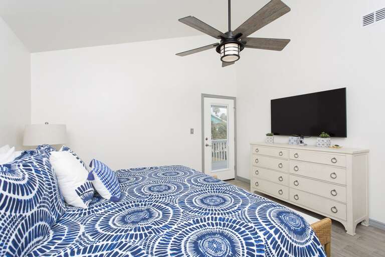 Large flat screen TV and private access to the shared balcony that over looks the pool area.