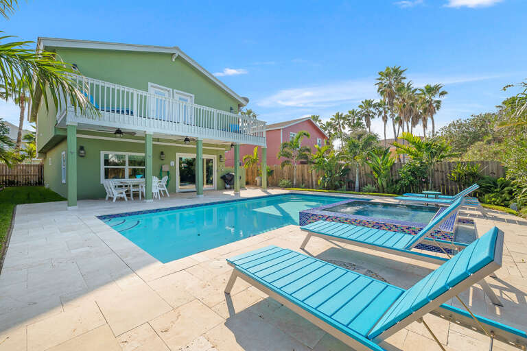 Large private pool and hot tub in the fenced in backyard.