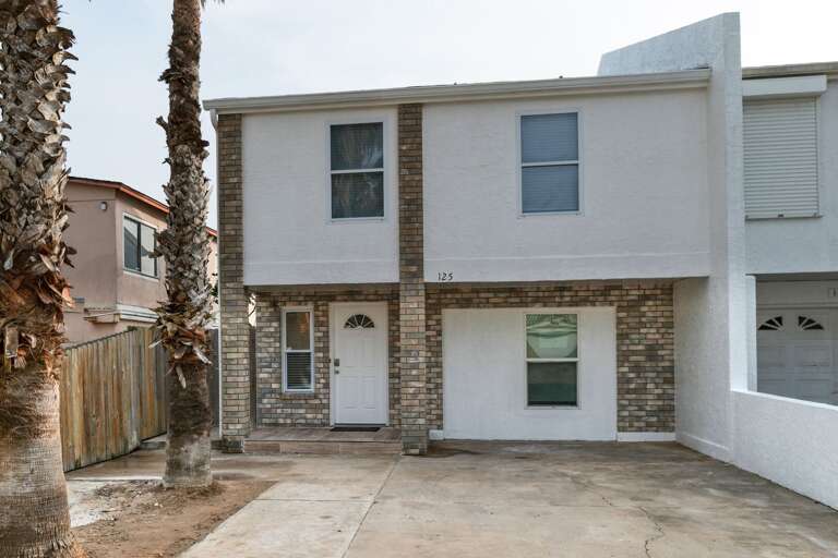 Front exterior of the rental home. Located just 1/2 block from the beach and popular beach bar & grill, Wanna Wannas!