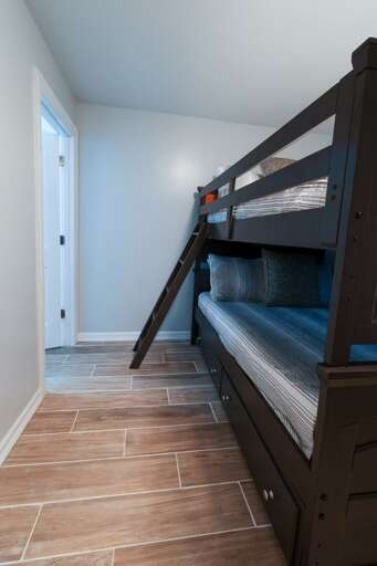 Guest bedroom on the ground floor with bunk beds and attached private bathroom. (1 of 4 total bedrooms).