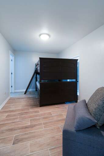 Guest bedroom on the ground floor with bunk beds and attached private bathroom.