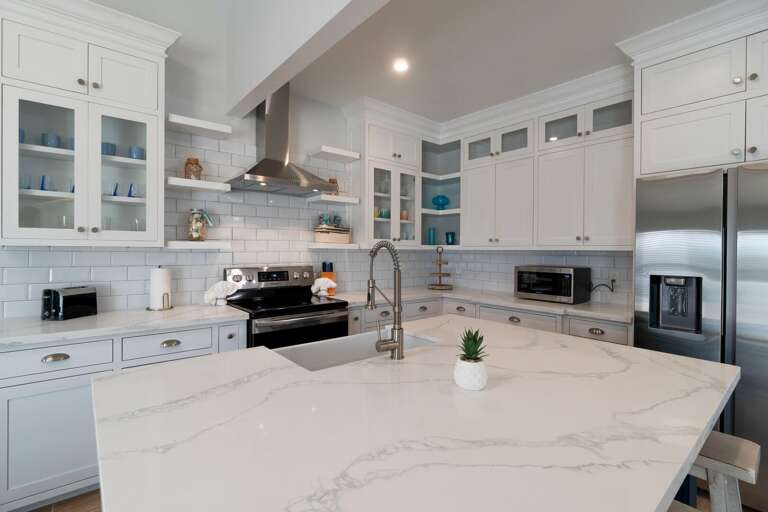 Modern kitchen with large center island and bar seating.