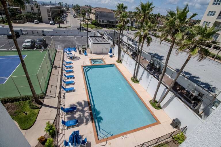 Aerial View Of Pool Flanked By Palms With Tennis Court Aerial View Of Pool Flanked By Palms With Tennis Court
