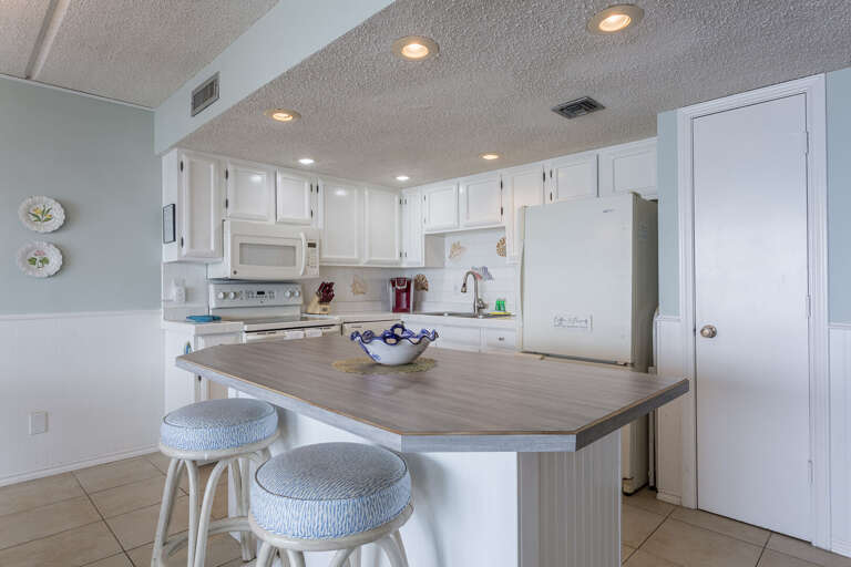 Fully equipped kitchen with pots, pans, cooking utensils, and glassware essential to prepare a home cooked meal!
