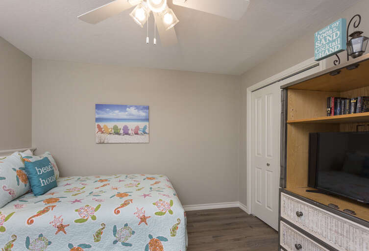 Beach-themed Bedroom With Sea-inspired Bedding, Book-filled Cabinetry, And Marine Motif Art