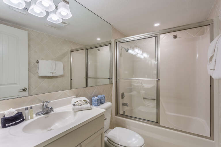 Master bathroom with combination bathtub/shoer.