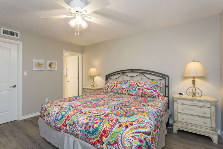 Master bedroom with King bed, flat screen TV and attached master bathroom.