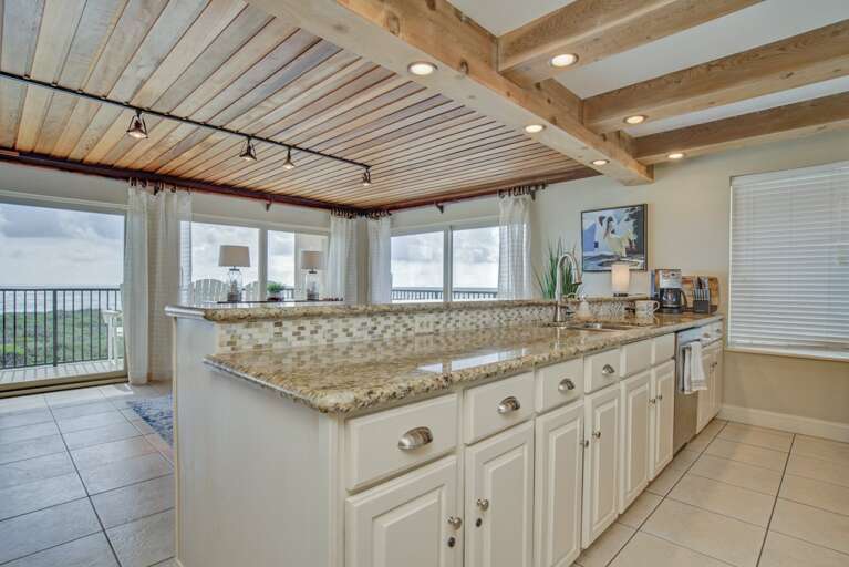 Open concept kitchen and dining area with granite countertops. Open concept kitchen and dining area with granite countertops.