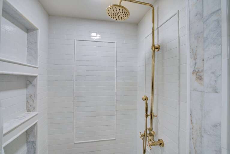 Walk-in shower in shared bathroom.