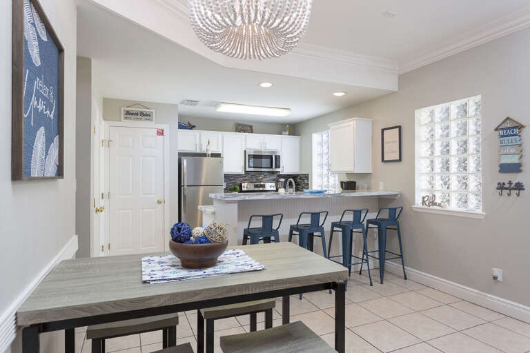 Fully stocked kitchen area featuring bar seating!