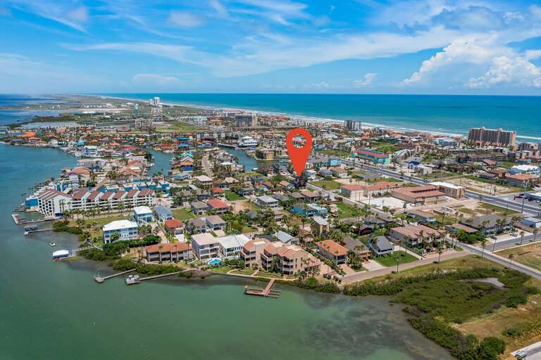Aerial of the house, bay to the left and beach to the right. Aerial of the house, bay to the left and beach to the right.