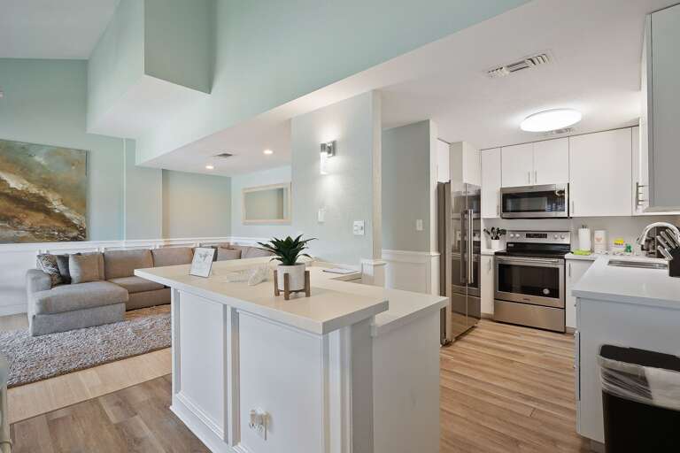 Kitchen with new stainless steel appliances & fully stocked with pots, pans, dish-ware and utensils.