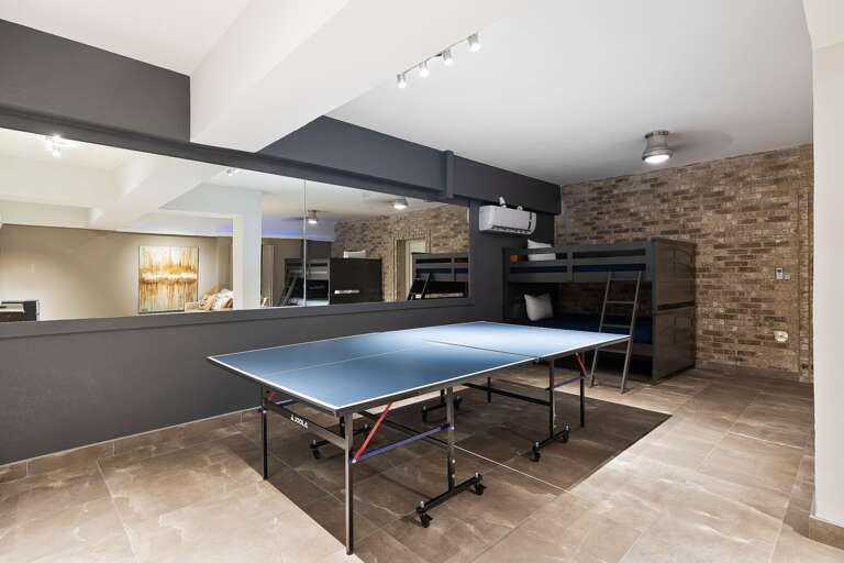 Ping Pong table in the 4th guest bedroom/media room. This room  is on the ground floor and has two sets of bunk beds with full over full size beds. Sleeps 8 guests.