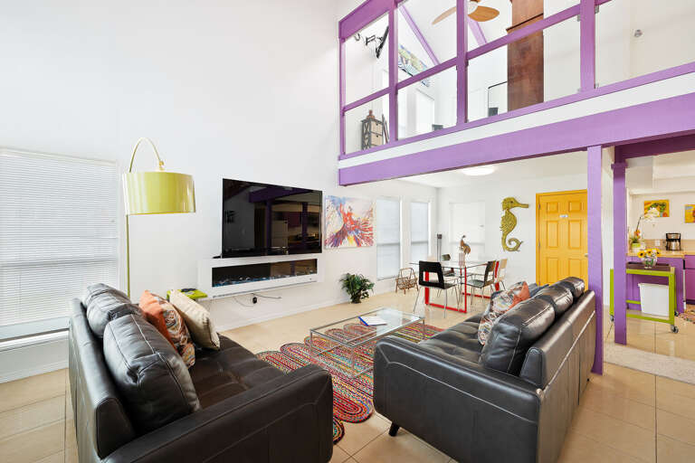 Great open living area with vaulted ceilings and a large flat screen TV and electric fireplace!