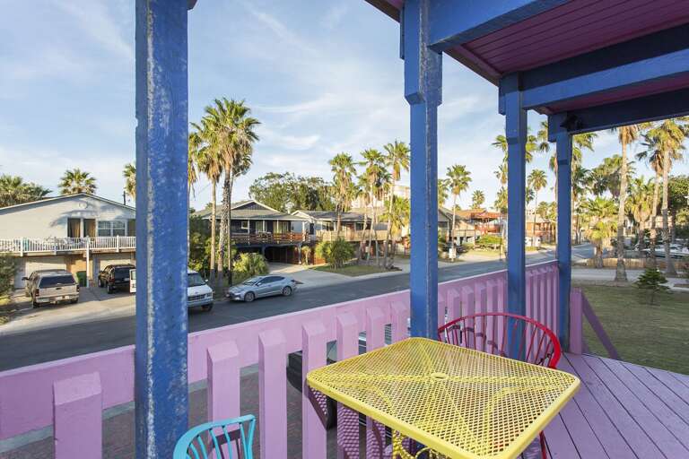 Front exterior of (B). Rental unit is located upstairs via pink staircase in the front of property.