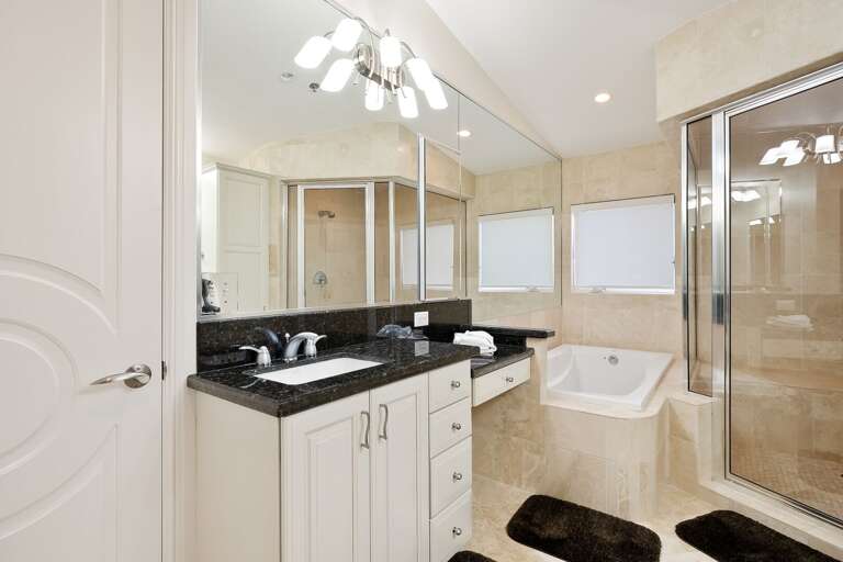 Bathroom in Master Bedroom A with tub, tiled walk-in shower, and double vanity sinks. Bathroom in Master Bedroom A with tub, tiled walk-in shower, and double vanity sinks.