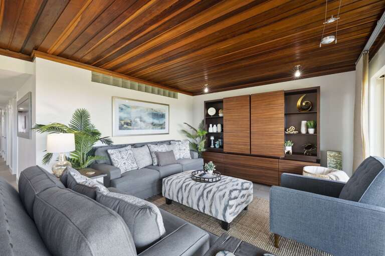 Ample seating featured in the living area, with a flat screen TV in the entertainment center.