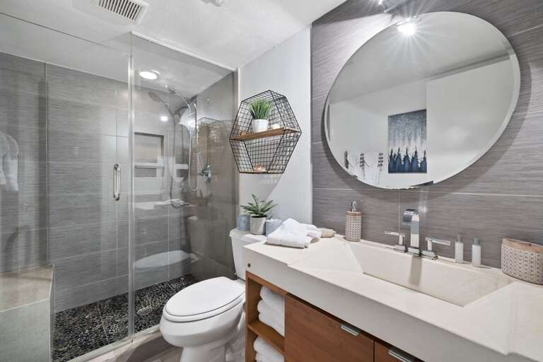 Full bath with tiled walk-in shower, located in bedroom 2.