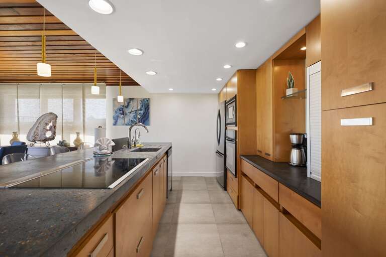 Kitchen is stocked with pots, pans, cookie sheets, crockpot, coffee maker, dishes, wine glasses, and more!