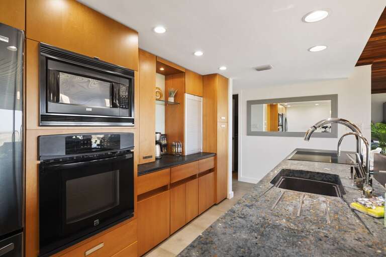 Kitchen is stocked with pots, pans, cookie sheets, crockpot, coffee maker, dishes, wine glasses, and more!