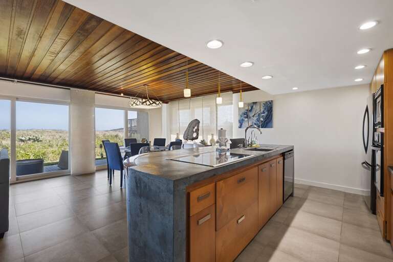 Kitchen is stocked with pots, pans, cookie sheets, crockpot, coffee maker, dishes, wine glasses, and more!