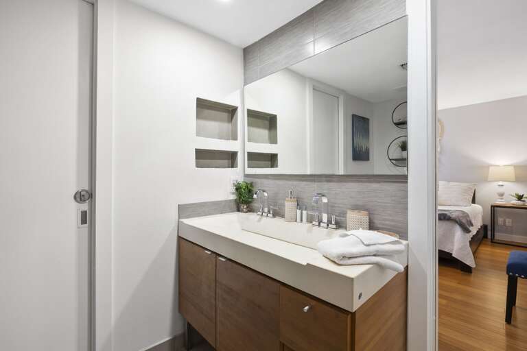 Master bathroom with tiled walk-in shower and double vanity sink.
