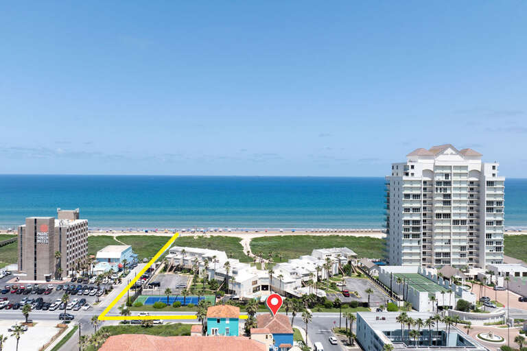 Seaside Coastal View With Buildings And Clear Sky