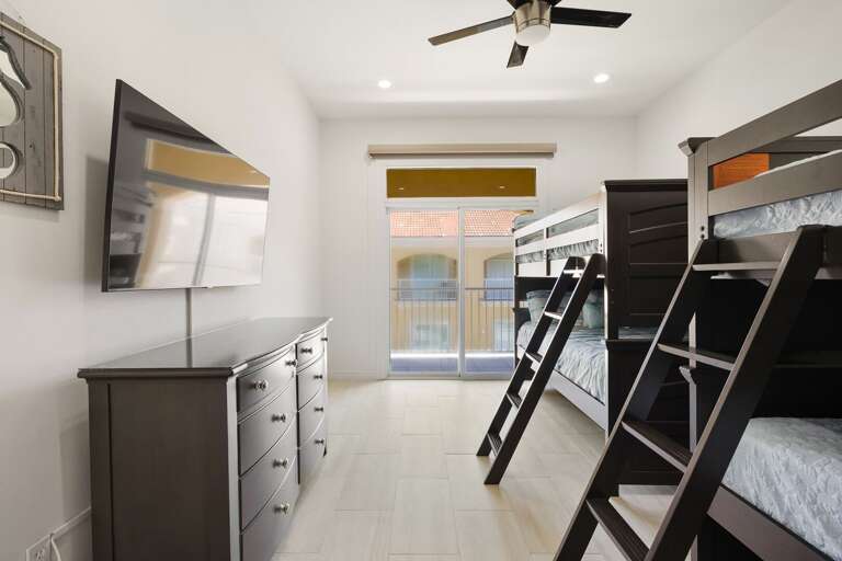 Bedroom 2 with 2 full bunk beds, sliding door to balcony
