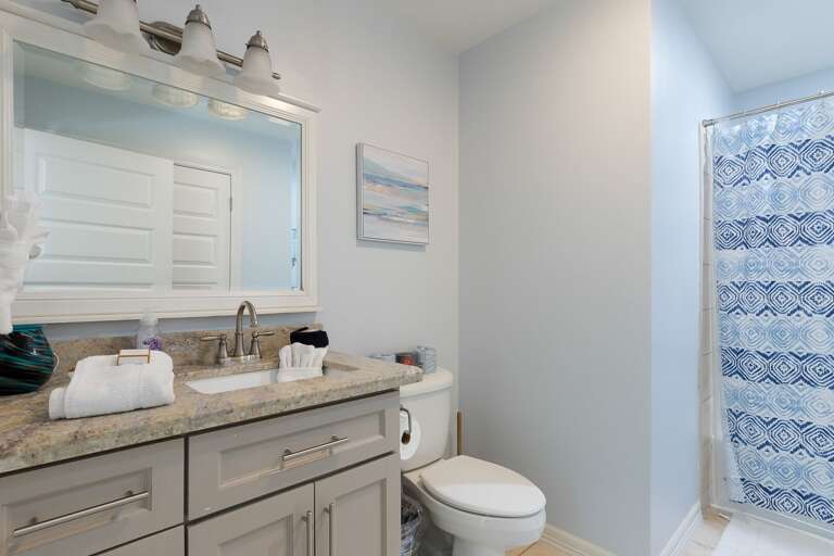 3rd floor bathroom with a combination shower/bathtub (located between Bunkhouse and Bayside suite)