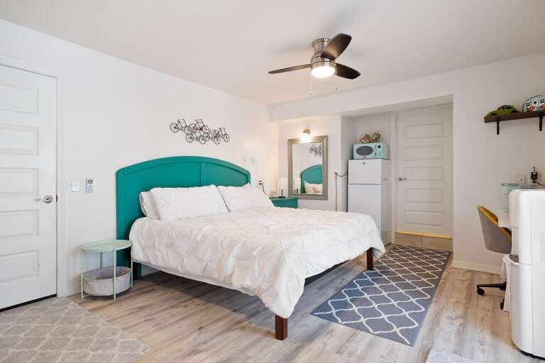 Poolside Suite: 1st floor private suite features king size bed, refrigerator, single cup coffee maker, microwave, small office desk, smart TV, and a daybed with twin trundle. Poolside Suite: 1st floor private suite features king size bed, refrigerator, single cup coffee maker, microwave, small office desk, smart TV, and a daybed with twin trundle.