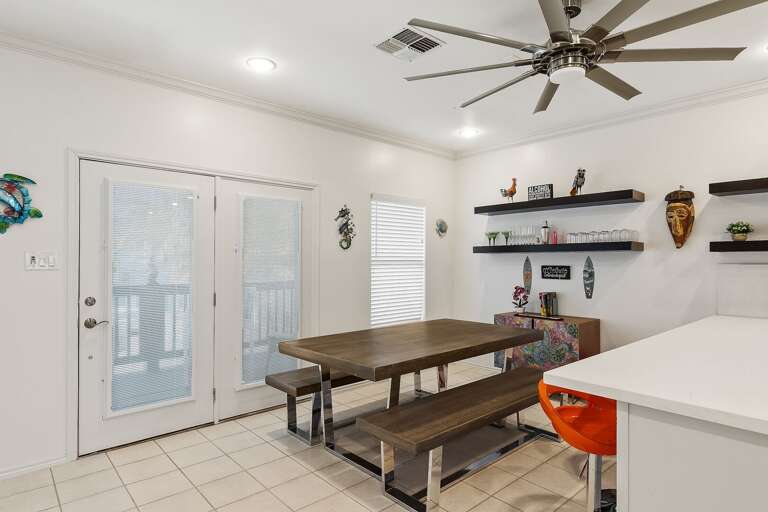 Dining area with picnic style table & additional seating at the bar.