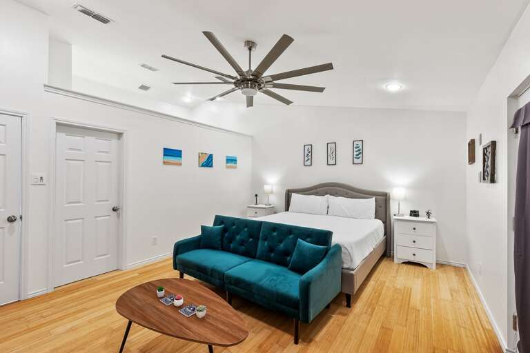 Master bedroom features a Queen size bed and beautiful sitting area in front of a flat screen TV.