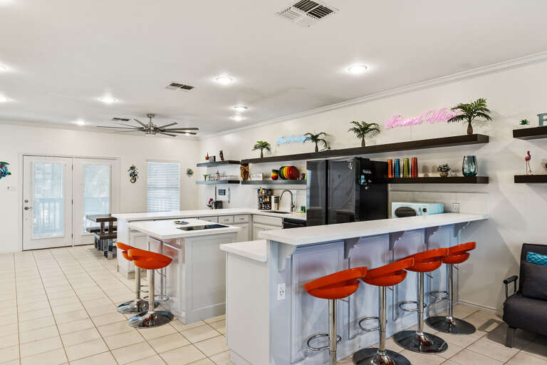 Open concept kitchen features wrap around bar seating (on all sides) and updated appliances!