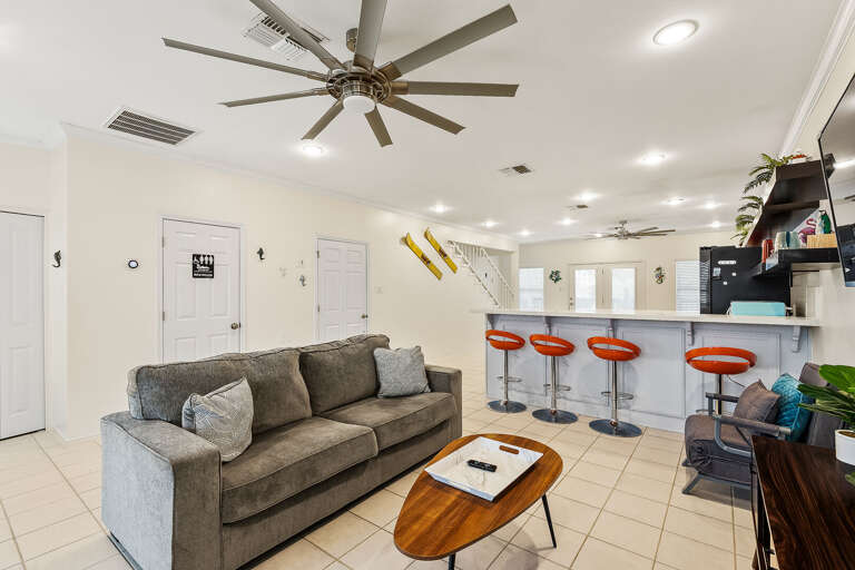 Open concept, living room, kitchen & dining area. Living room features a flat screen TV.