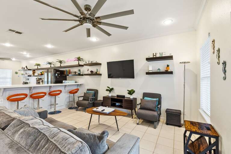 Open concept, living room, kitchen & dining area. Living room features a flat screen TV.