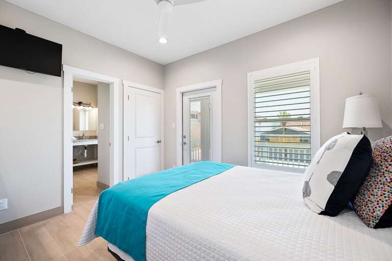 Guest bedroom features pati access facing the road