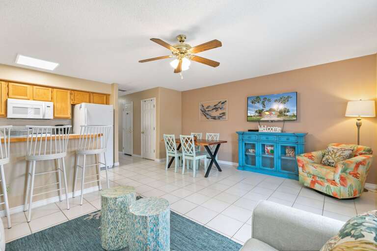 Open Concept Living Room with seating surrounding a Flat screen TV